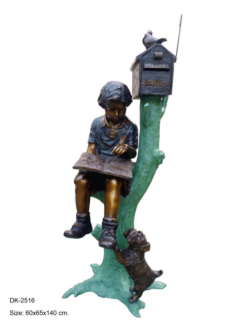 Reading boy on tree mailbox Reading boy on tree mailbox
